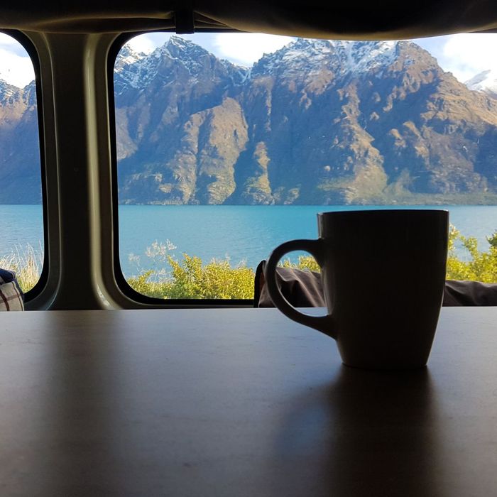 cup of coffee on table of campervan