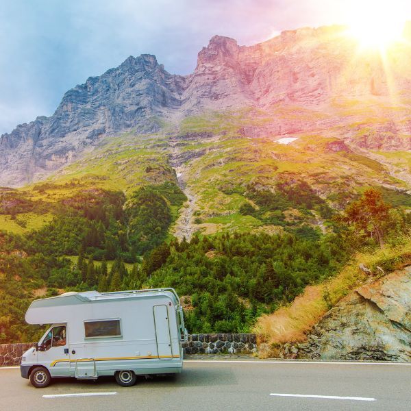 Camper driving by beautiful scenery. 