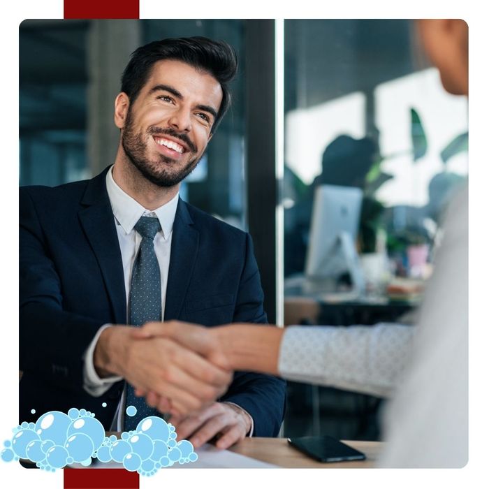 A man in a suit shaking hands with someone.