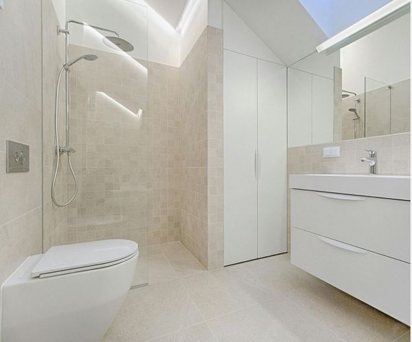 Modern bathroom with walk-in shower and light tile, showcasing quality remodeling