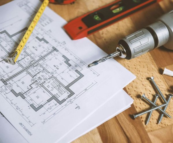 Construction blueprints with drill and tools for project planning