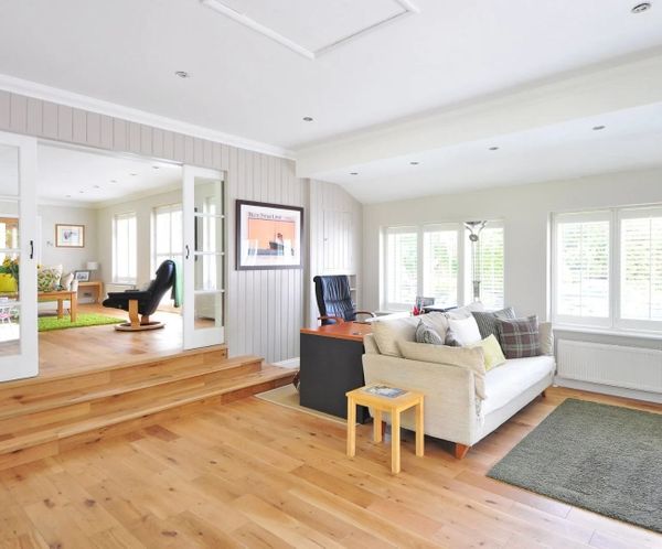 Bright open-concept living space with light wood floors and white ceiling