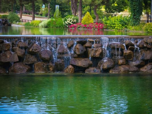 Beautiful man-made waterfall and pond in a landscaped park