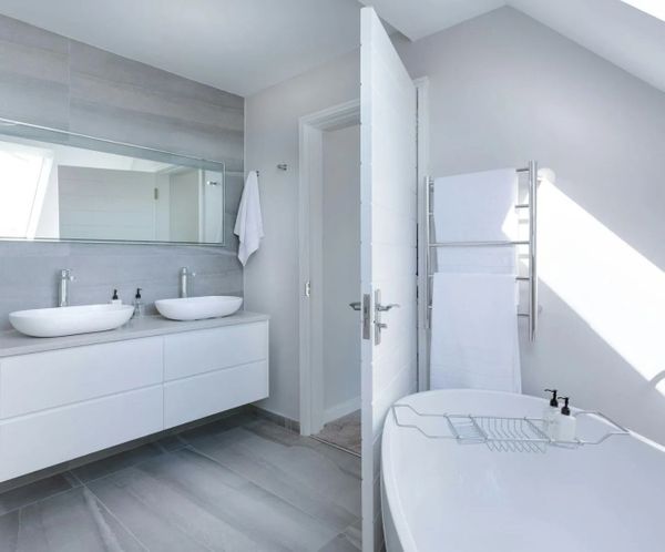 Modern bathroom with floating double vanity, vessel sinks, and freestanding tub