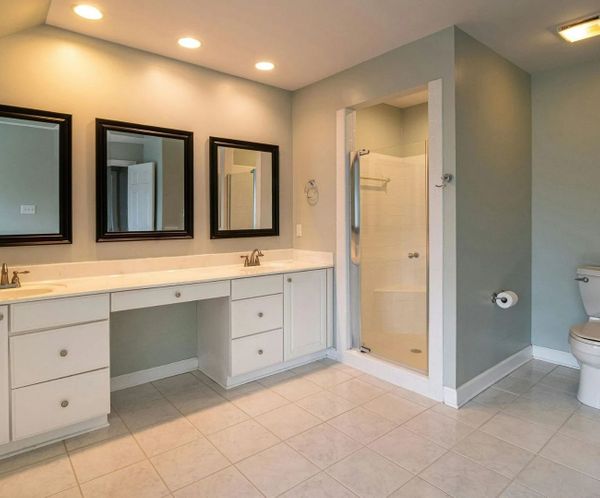 Spacious modern bathroom with double vanity and glass shower enclosure