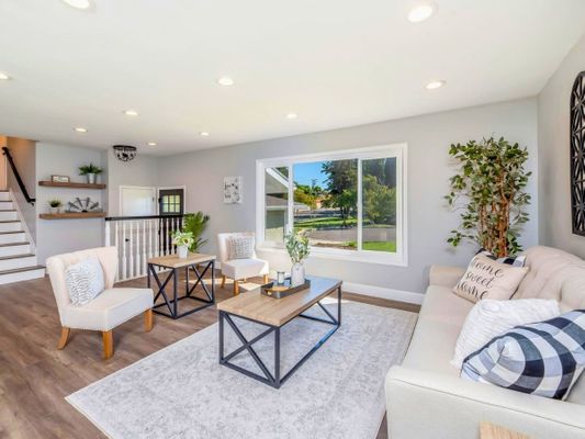 Bright, newly renovated living room with hardwood floors and modern furniture