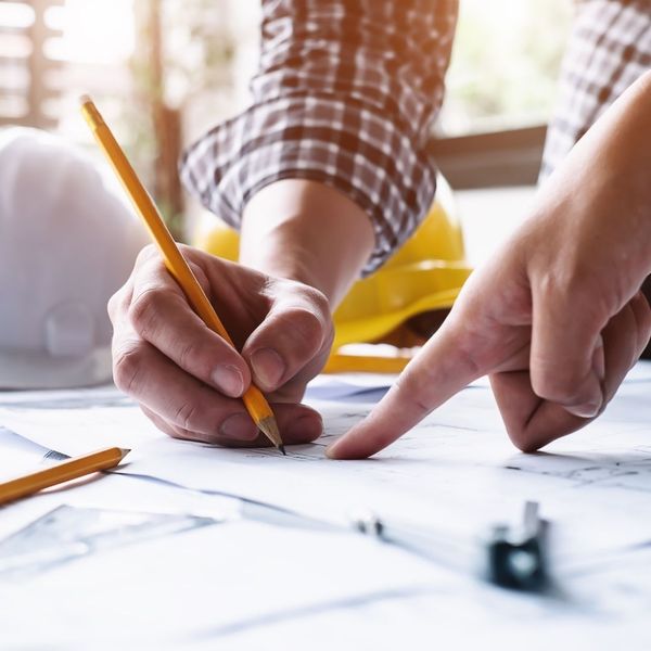 person drawing civil engineering plan