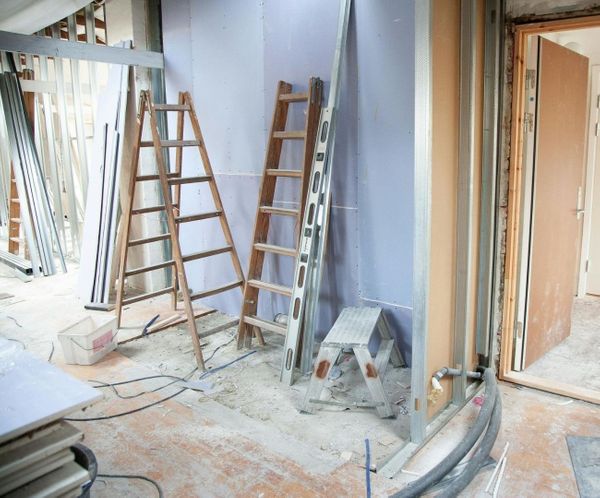 Interior construction site with drywall and metal framing during a remodel