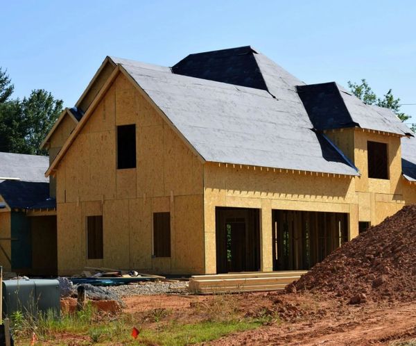 Wood frame of a new residential house under construction on a building site