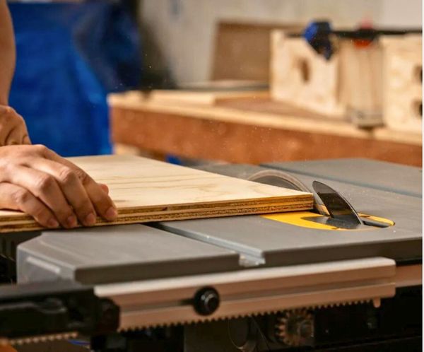 Skilled craftsman cutting wood with a table saw for custom construction
