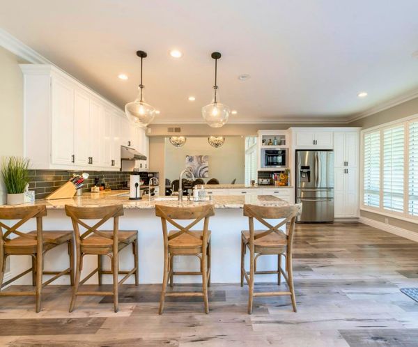 Modern kitchen with white cabinets and a large island, perfect for residential remodeling