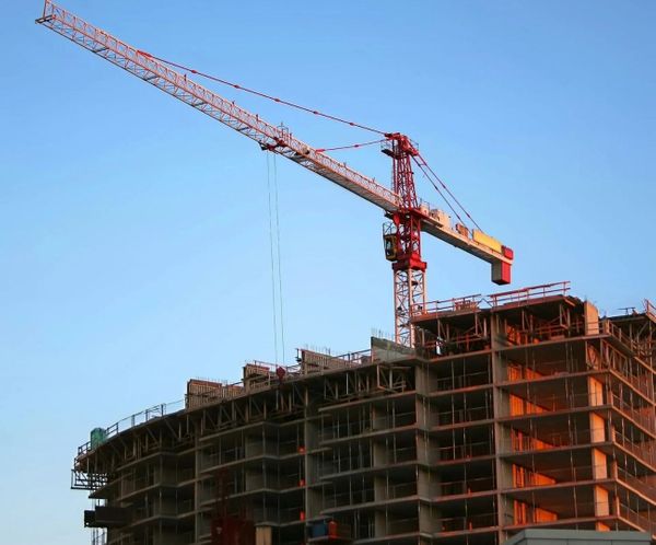 Tower crane overlooking a multi-story commercial building under construction