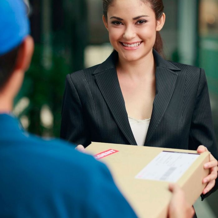 woman smiling while receiving a package