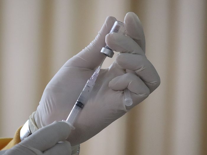 Healthcare professional filling up a vaccine