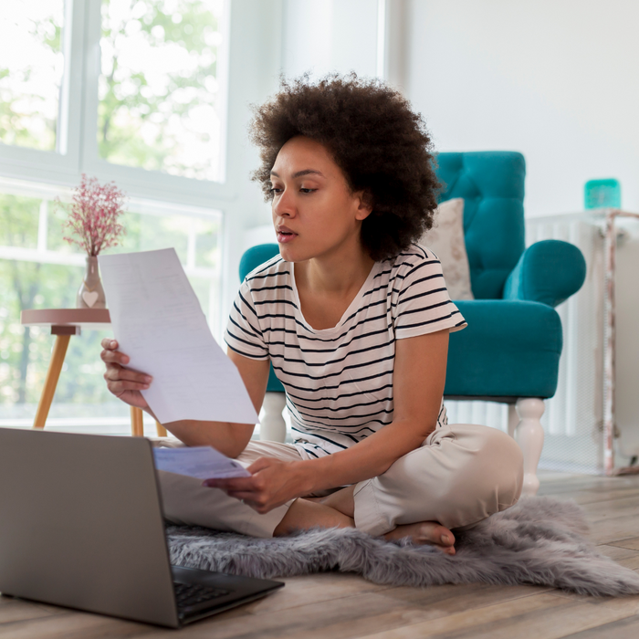 woman looking over her paystub