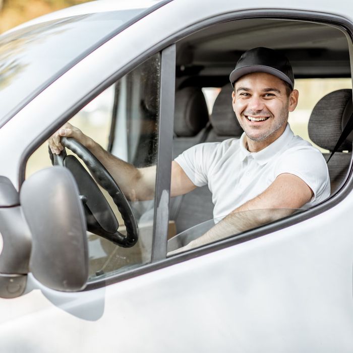 smiling delivery driver in truck