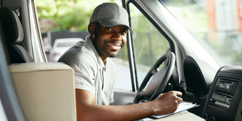 Deliver man smiling in his truck