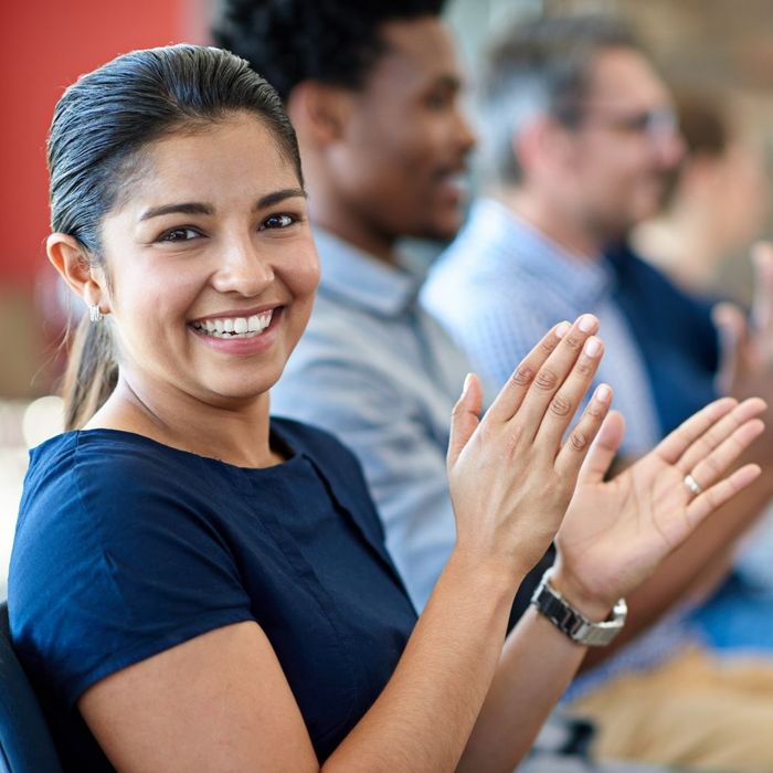 woman smiling and clapping