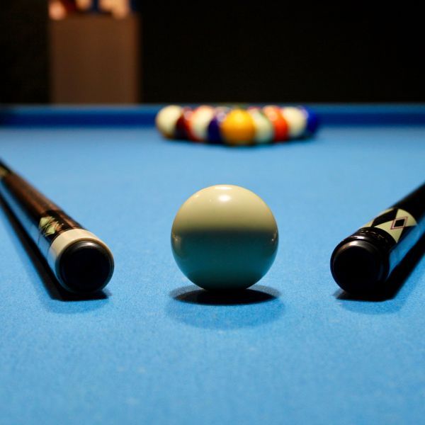 pool sticks and ball on table