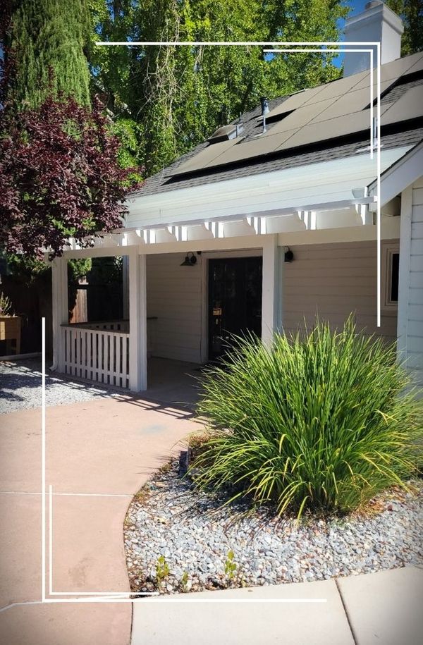 wooden pergola on the front side of house