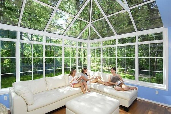 sun room with family on couch