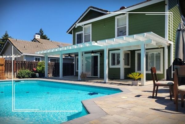 wood pergola outside of house near pool