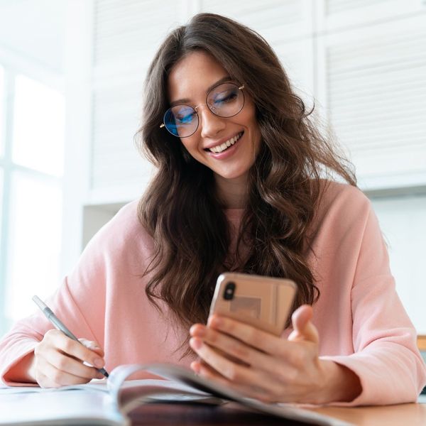 busy woman looking at phone and schedule