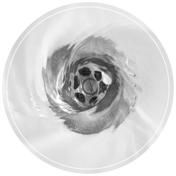 Top-down close-up view of clear water swirling smoothly down a white porcelain sink drain.