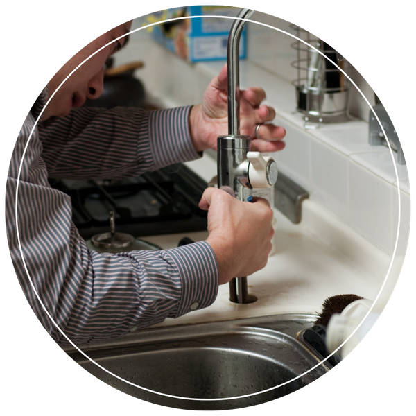 plumber installing new kitchen faucet 