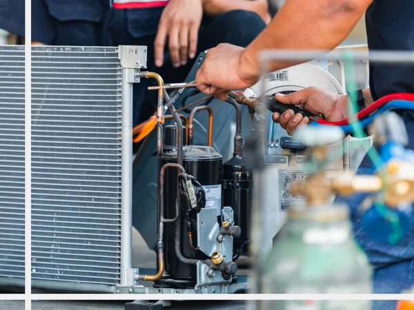 using a torch to perform maintenance on an a/c unit