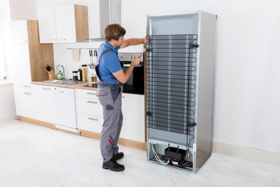 img of someone working on a freezer