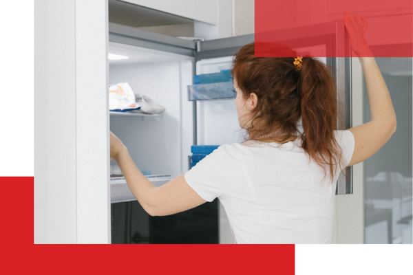A woman reaching into her freezer