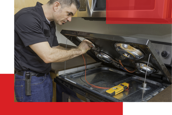 a appliance repairman fixing a stovetop Dacono (3).png