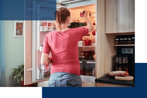 woman standing in front of refrigerator