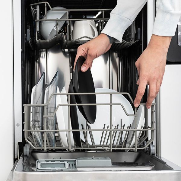 person loading a dishwasher