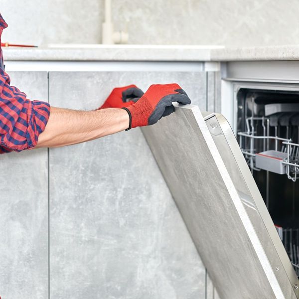 Repair man opening dishwasher