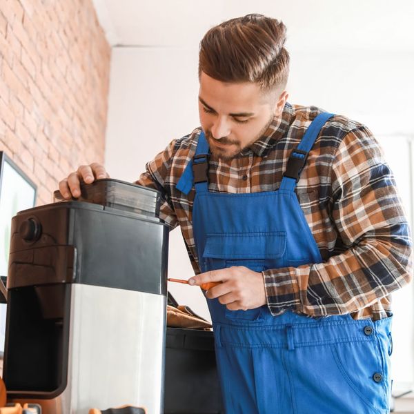 A repairman fixing an appliance