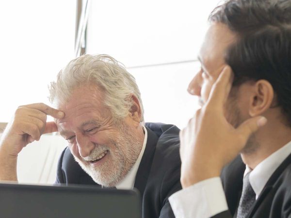 two business men are chatting and laughing together