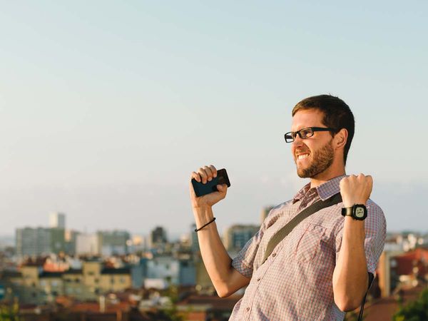 a man holding a phone who got some great news