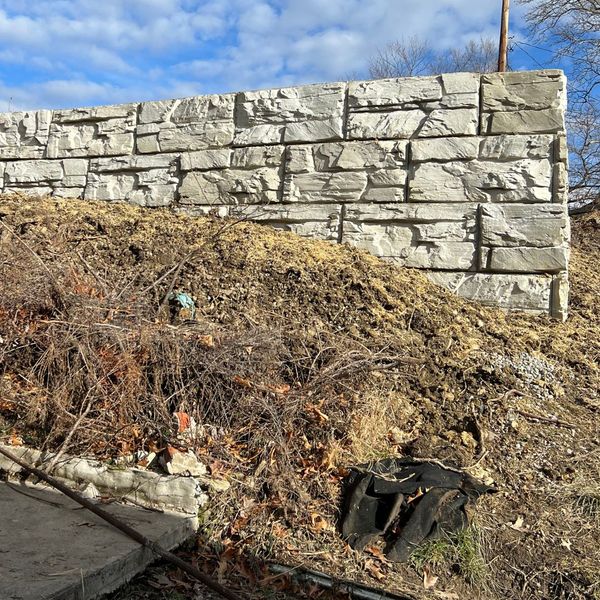 textured stone wall on sloped ground