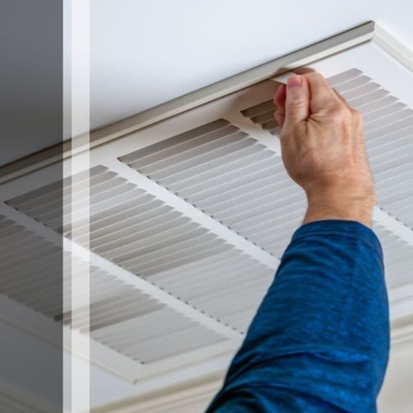 AC contractor checking an air vent