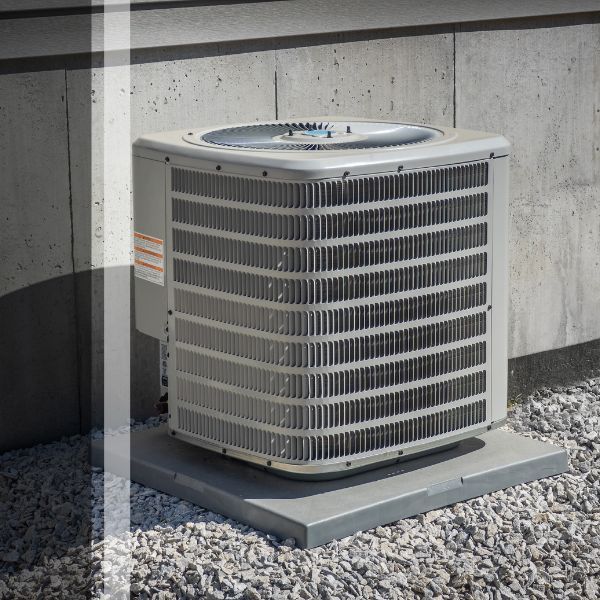 HVAC unit outside of home on gravel patch
