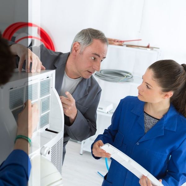 HVAC techs repairing unit.