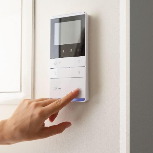 person adjusting a thermostat
