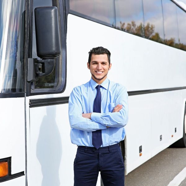 driver standing outside a charter bus