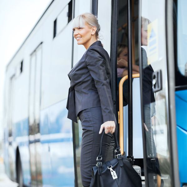 woman getting off of a bus