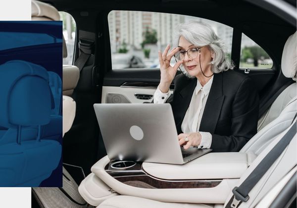 VIP woman sitting in vehicle on her laptop VIP woman sitting in vehicle on her laptop