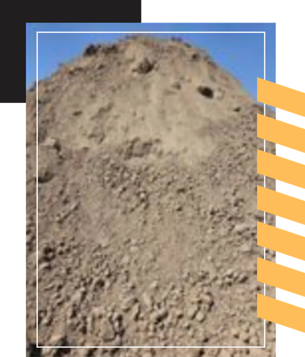 A large pile of dark, loose topsoil against a blue sky.