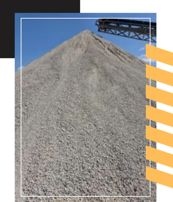 A tall, pointed heap of light-colored gravel with a conveyor belt visible at the top.