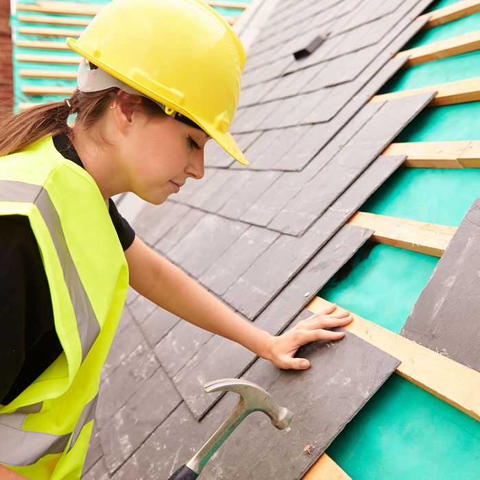 A woman building a roof